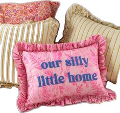 three pillows with the words our silly little home on them