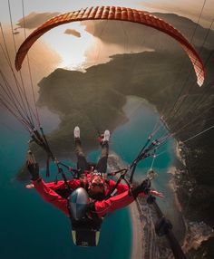 a man flying through the air while riding a parachute