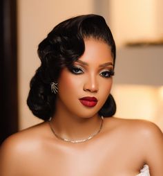 a woman with dark hair wearing a white dress and red lipstick is posing for the camera