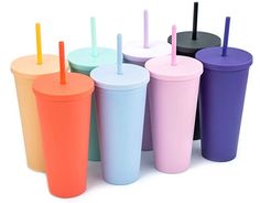 a group of different colored cups with straws in them on a white background,