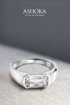 a white gold ring with two baguettes on it