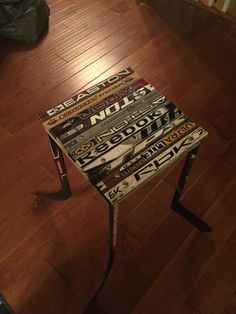 a chair made out of magazines sitting on top of a hard wood floor