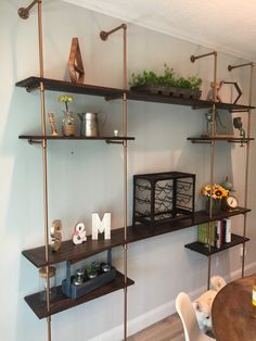 some shelves with flowers and plants on them in a living room or dining room area