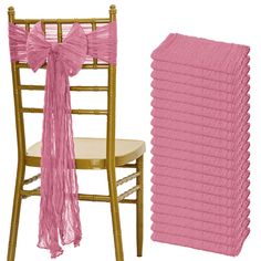 a chair with pink chiffon ruffles on it next to a stack of chairs