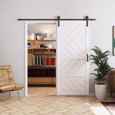 a living room with a couch, chair and sliding barn door