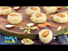 almonds and pistachio cookies on a wooden cutting board with the words tarla dala