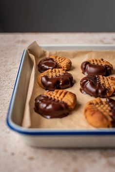 chocolate covered cookies in a baking pan on a counter