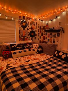 a bed room with a checkered comforter and lots of pictures on the wall