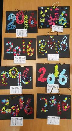 the numbers are made out of black paper with colorful dots on them and pinned to bulletin boards