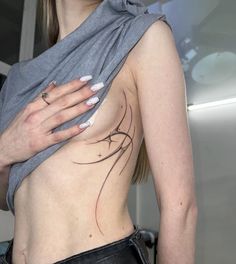 a woman with tattoos on her chest holding onto another person's arm and shoulder