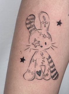 a black and white drawing of a cat with stars on it's leg,