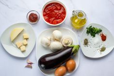 an assortment of food on plates with sauces and condiments in bowls next to them