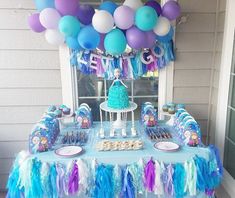 a frozen princess birthday party complete with cake, balloons and streamers on the table