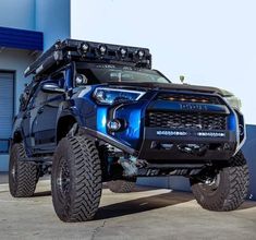 a large blue truck parked in front of a building