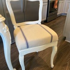 a white chair sitting on top of a hard wood floor