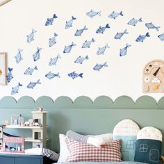 a bed room with a neatly made bed and a clock on the wall above it