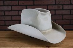 Inspired by the hat worn by Steve McQueen in the classic western film, Magnificent Seven. Crown: 4-1/4" Brim: 3-1/2" Color: Silverbelly Hatband: 2 ply matching ribbon Handmade to Order Estimated delivery: 8-12 weeks *Please note hat in photo is aged Want to know your hat size? Service Policy at http://baronhats.com/index.php/customer-service By submitting this order you understand, agree and accept all conditions as set forth in our Service Agreement, including, but not limited to our custom hat