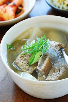 a bowl of soup with meat and vegetables in it