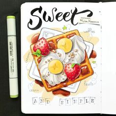 a book with some food on top of it and a marker pen next to it