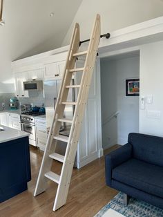 a living room with a couch and a ladder