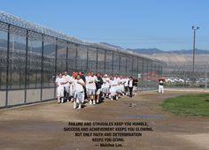 a group of men standing next to each other on a baseball field with a fence in the background