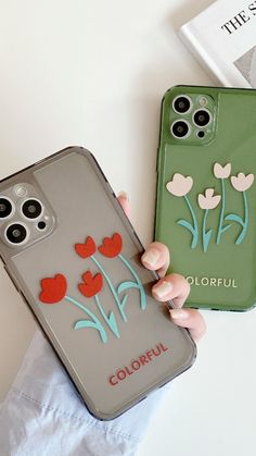 two cases with flowers painted on them, one is green and the other is grey