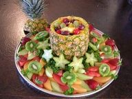 a fruit platter with pineapples, grapes, kiwi and strawberries