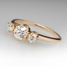 three stone diamond ring in yellow gold