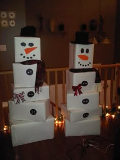 two snowmen made out of boxes sitting on top of each other