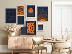 a dining room table with chairs and art on the wall