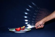 a person is reaching for some fruit on a plate