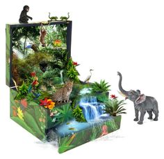 an open suitcase with pictures of animals and plants on the front, inside which is a jungle scene