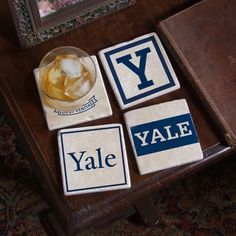 four coasters with the letters y, y and y are sitting on a table