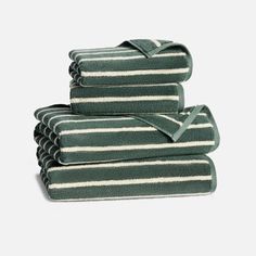 towels stacked on top of each other in green and white striped pattern, folded neatly