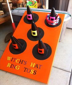 an orange sign that says witch hat ring toss on top of some sort of cones