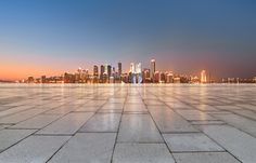 an empty concrete floor with the city skyline in the background