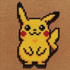 a close up of a piece of art made out of lego blocks with pikachu on it