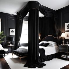 a black and white bedroom with four poster bed