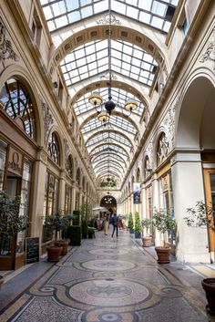 the inside of an indoor shopping mall with lots of windows