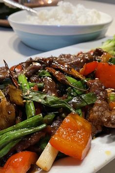 a white plate topped with meat and veggies