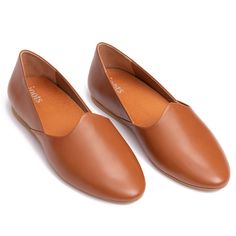 two brown shoes on top of each other