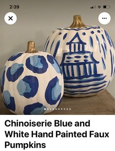 two blue and white painted pumpkins sitting next to each other