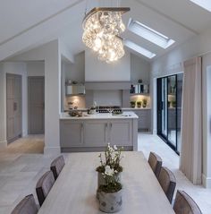 an open kitchen and dining room with skylights