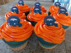 cupcakes with orange frosting and black bears on top