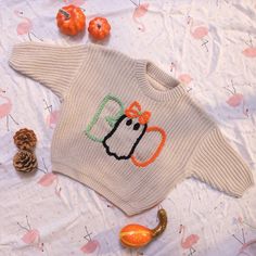 a knitted sweater with a pumpkin on it