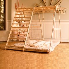 a bunk bed made out of wood with lights on the wall