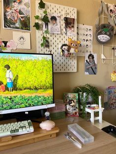 a computer monitor sitting on top of a wooden desk next to a keyboard and mouse