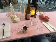 a table topped with wine glasses and ice cream