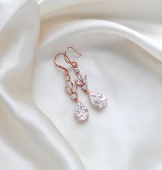 If you are searching for a beautiful pair of CZ bridal earrings that bring together rose gold and cubic zirconia, these long dangle earrings are exactly what you need. Elegant and refined, these earrings will complement a long neck and they will elongate the entire face, creating a look that is feminine, sophisticated, and ultra-elegant. A gorgeous accessory for a bride who enjoys the perfect combination between “dainty” and “one of a kind”! - Earrings measure 2-1/8" x 3/8" - Rose gold finish- Premium Cubic zirconia stones - Nickel free - Available in rose gold, yellow gold and rhodium finish. PLEASE ALLOW APPROX 5 BUSINESS DAYS FOR COMPLETION BEFORE SHIPPING. This is an original design by © Treasures by Agnes FOR MATCHING PIECES SIMPLY TYPE "LAUREN" IN THE SEARCH BAR Elegant Rose Gold Drop Bridal Earrings, Elegant Rose Gold Bridal Drop Earrings, Elegant Rose Gold Long Drop Earrings, Elegant Rose Gold Dangle Linear Earrings, Rose Gold Cubic Zirconia Bridal Earrings For Formal Events, Rose Gold Cubic Zirconia Bridal Earrings For Formal Occasions, Formal Rose Gold Bridal Earrings With Cubic Zirconia, Elegant Rose Gold Chandelier Earrings With Cubic Zirconia, Elegant Rose Gold Teardrop Earrings With Cubic Zirconia