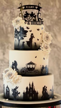 a three tiered cake decorated with black and white silhouettes